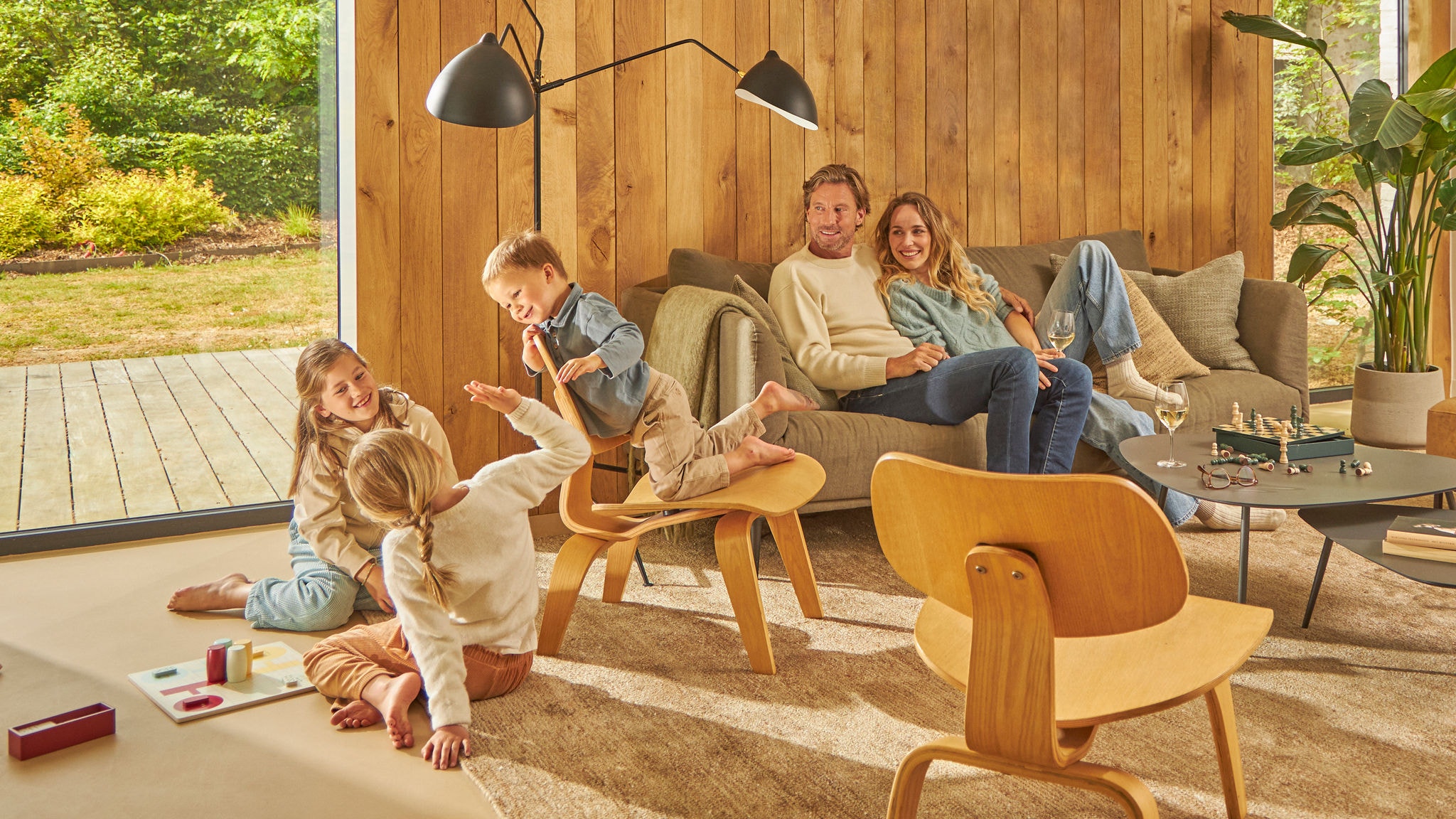 Family of four laughing while playing a board game in their ventilated kitchen