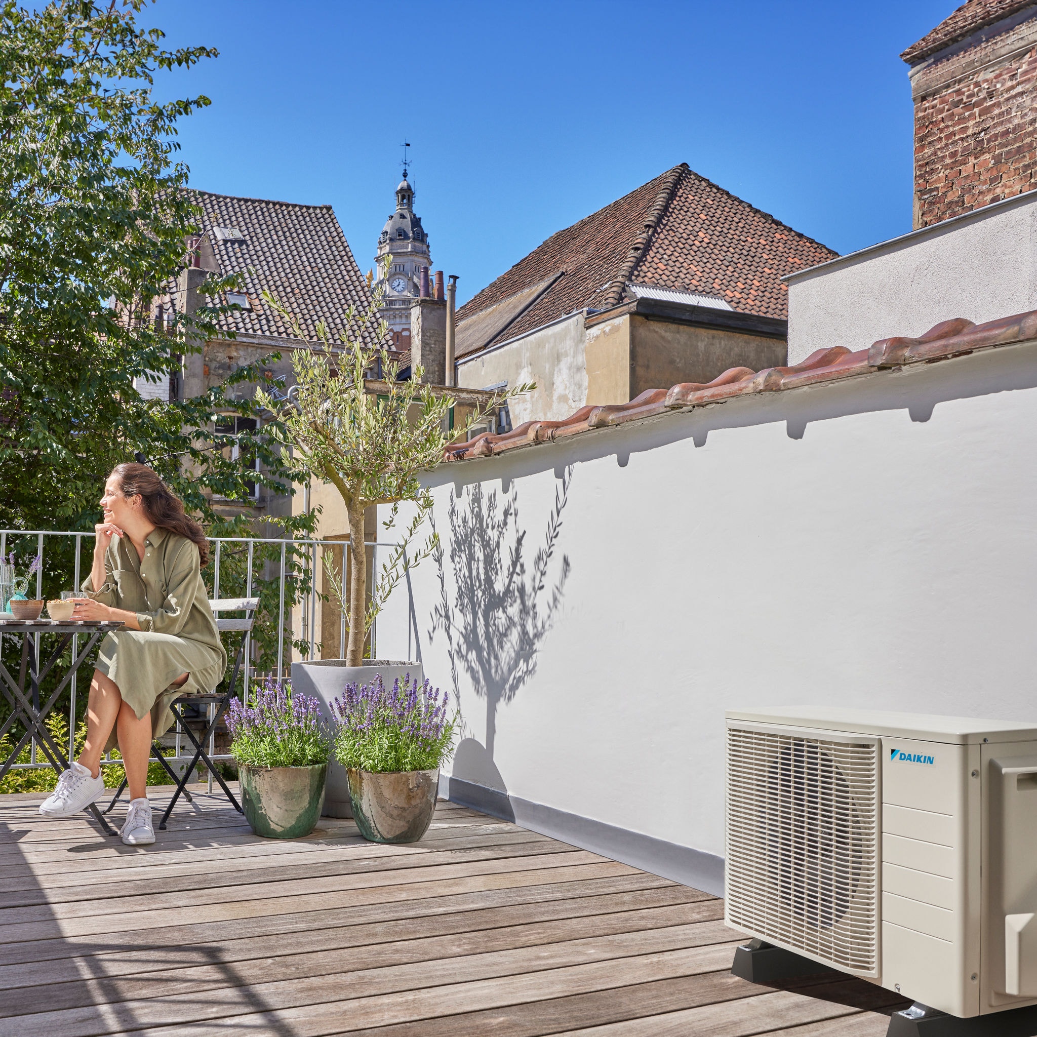 A woman relaxes on her sunny outdoor terrace